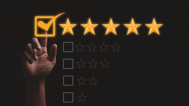A hand selecting a five-star rating
