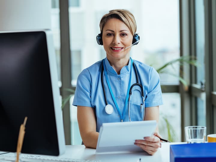 A smiling clinic team member with a headset, ready to answer questions